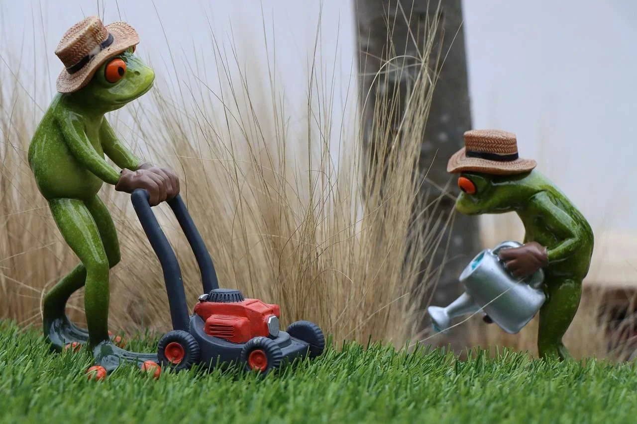 Grounds maintenance crew working on a lawn with professional mowing equipment