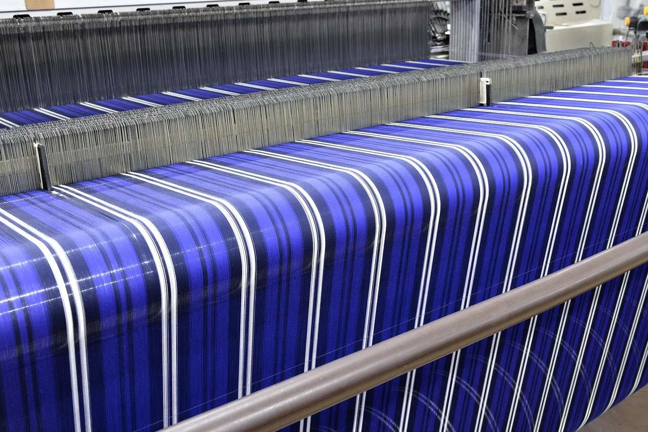 Industrial textile machine running yarn in a fabric mill