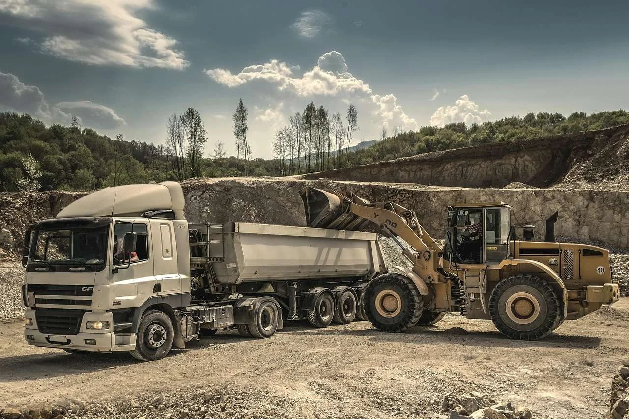 Excavator loading a lorry at a quarry, plant bought on hire purchase