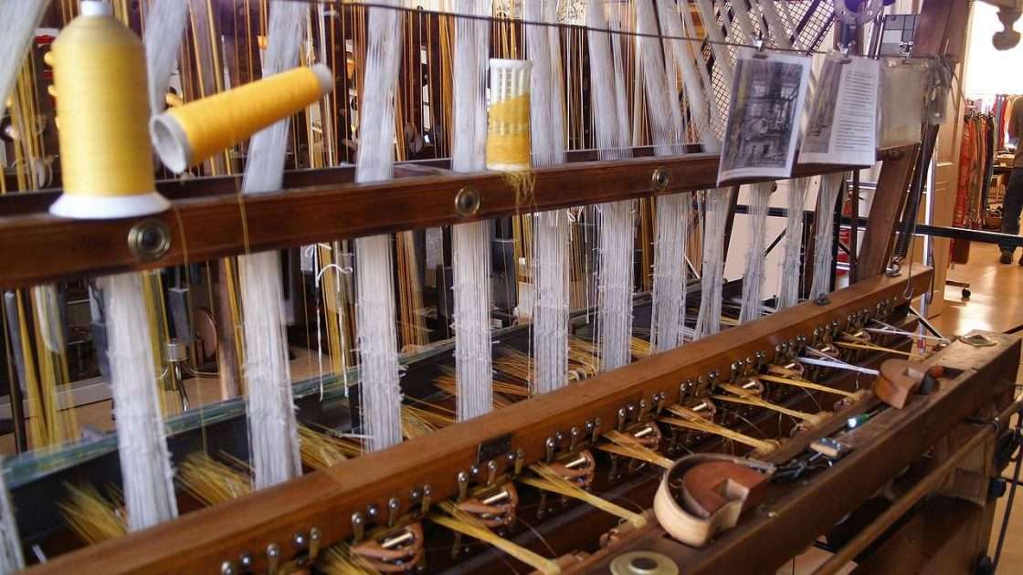 Jacquard loom weaving fabric in a textile factory, machinery funded through asset finance for textile manufacturers