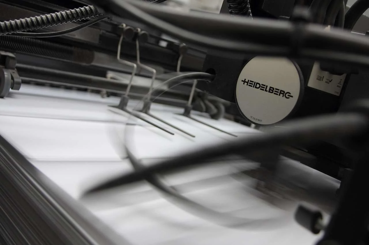 Printed sheets running through a commercial offset press