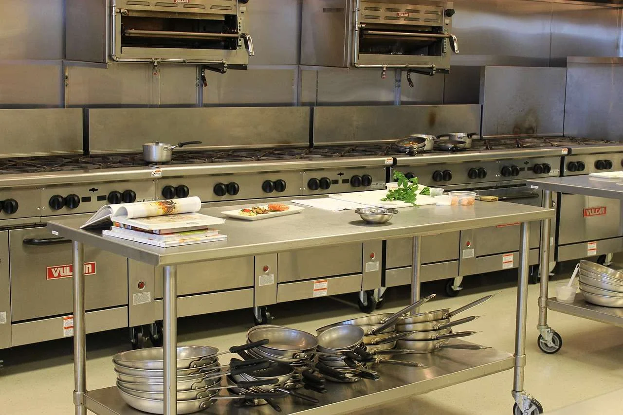 Commercial kitchen with stainless steel catering fridges and prep counters