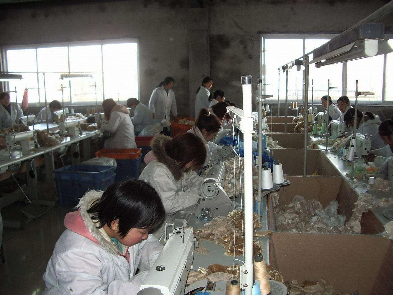 Machinist working at an industrial sewing machine in a garment factory