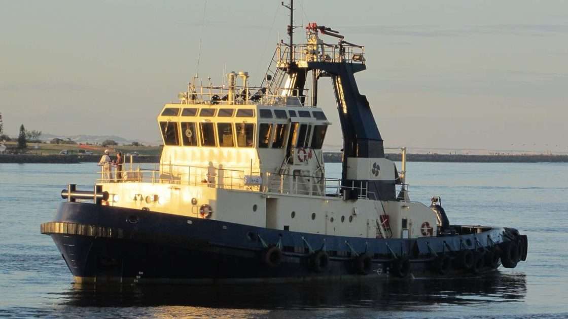 Harbour tug working alongside a ship, a commercial vessel funded through commercial vessel finance