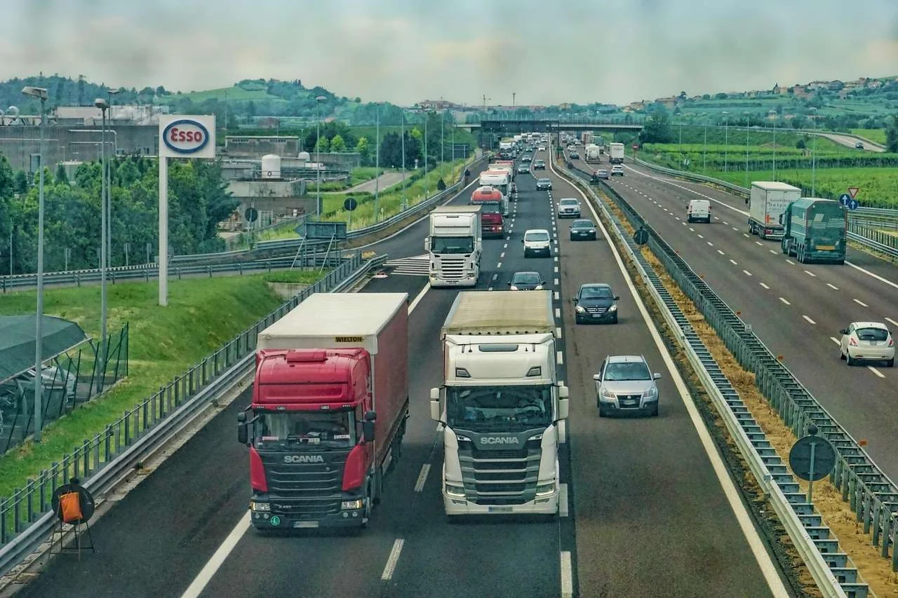 Articulated lorries with curtainside and box trailers on a motorway