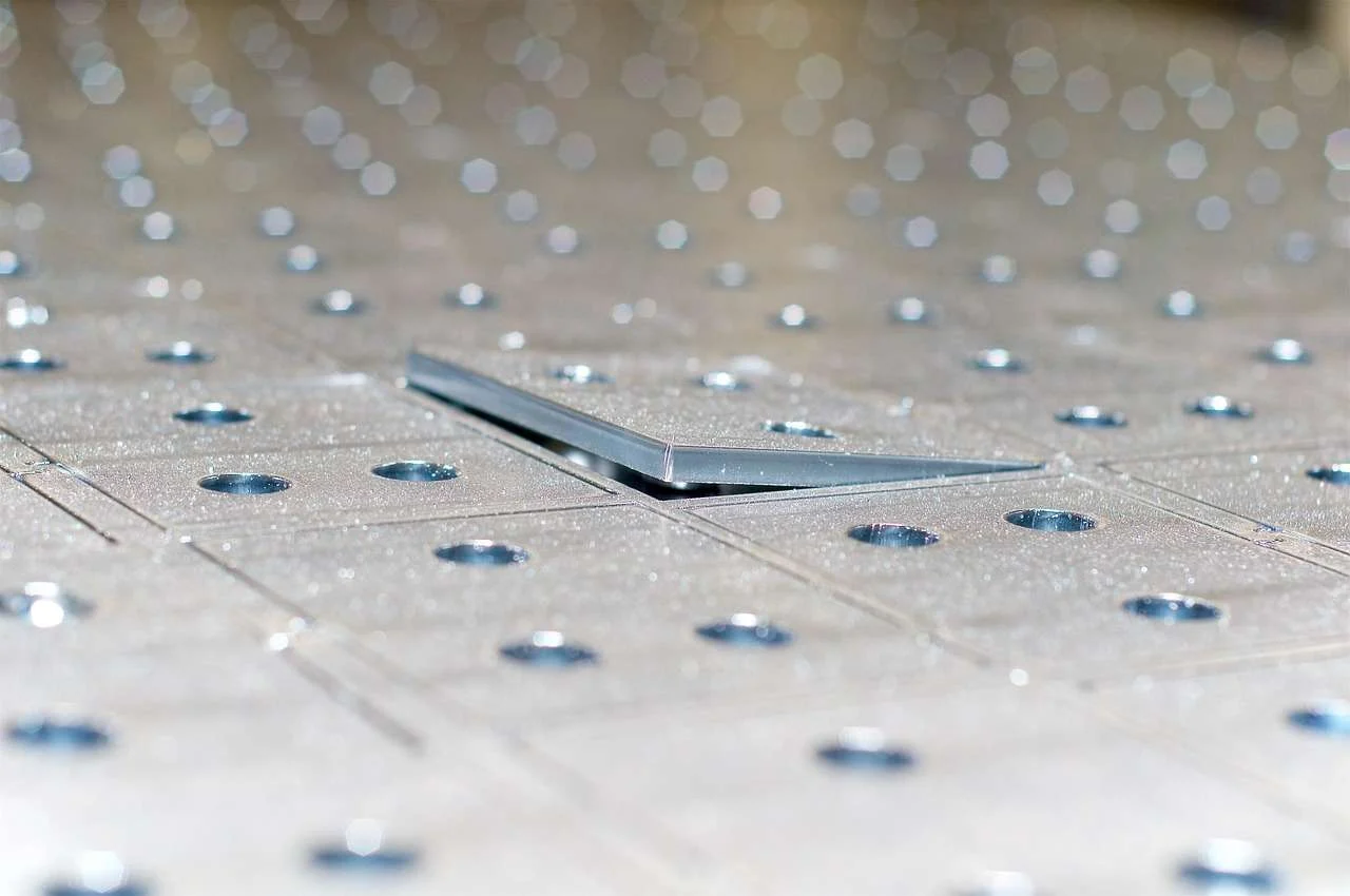 Laser-cut sheet metal part with a pattern of precision holes