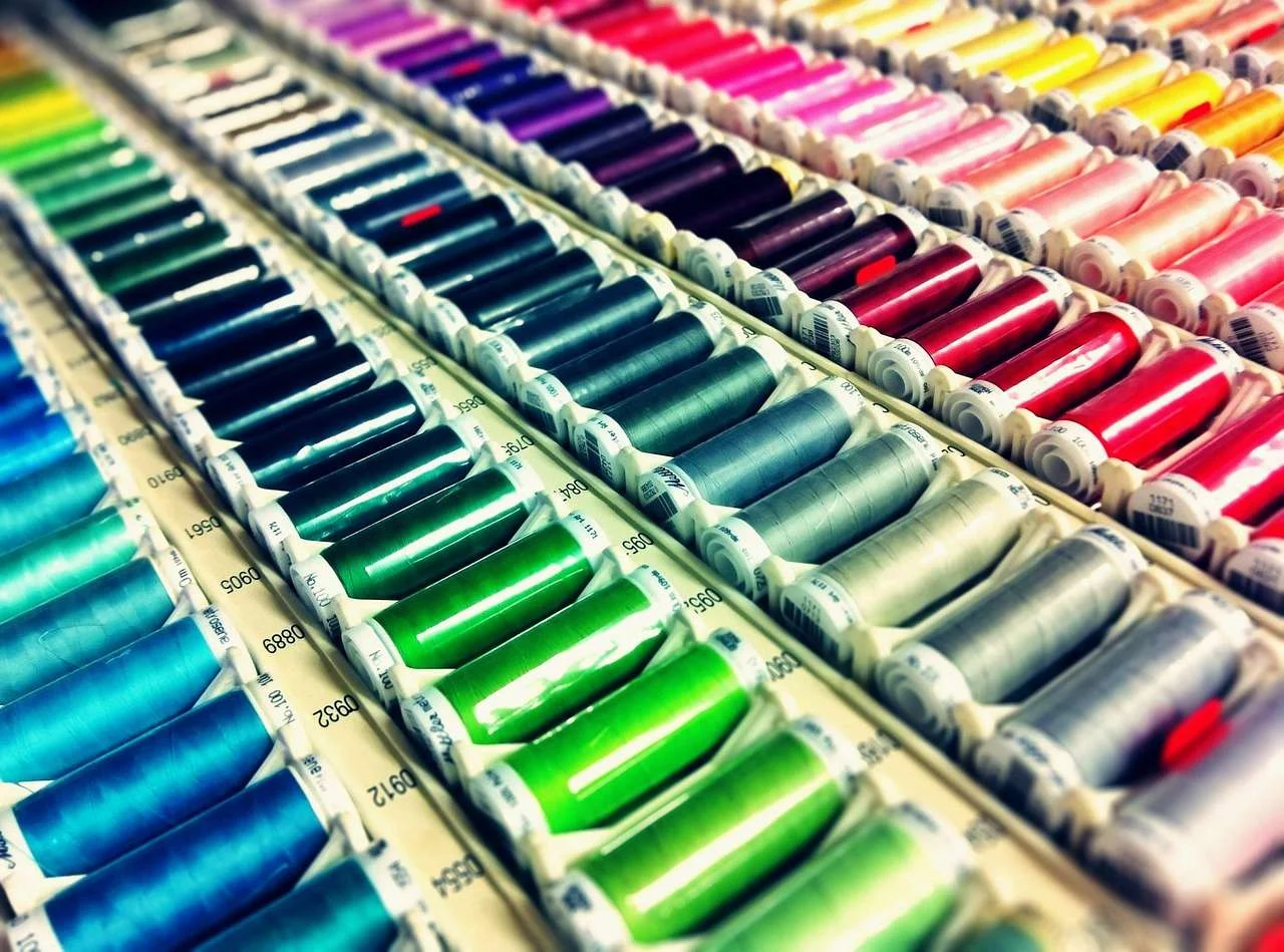 Cones of coloured thread used on commercial embroidery and sewing machines