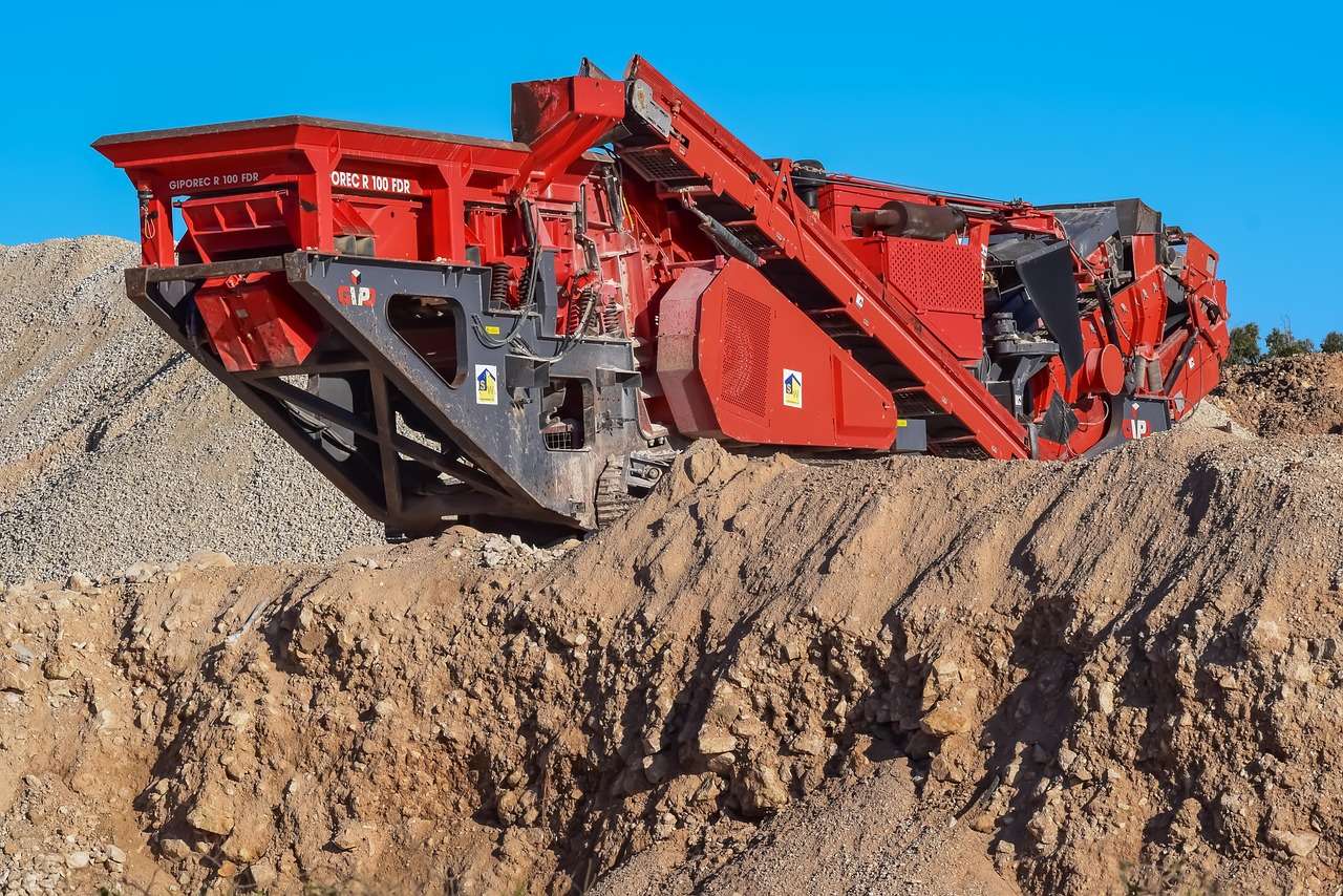 Tracked crusher working a quarry face, the processing plant quarry operators fund through asset finance