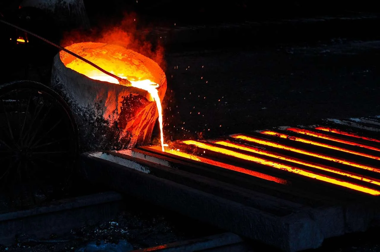 Molten metal being poured from a melting furnace