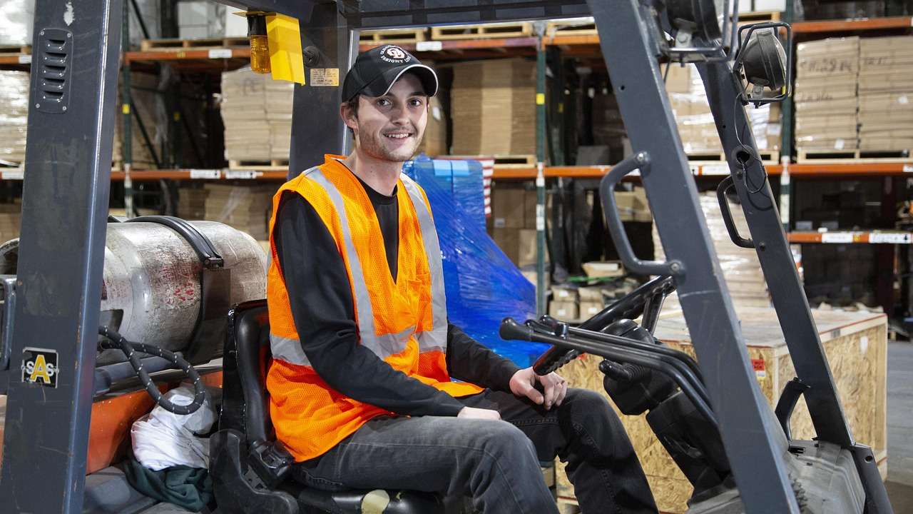 Forklift truck finance for a forklift lifting pallets in a warehouse