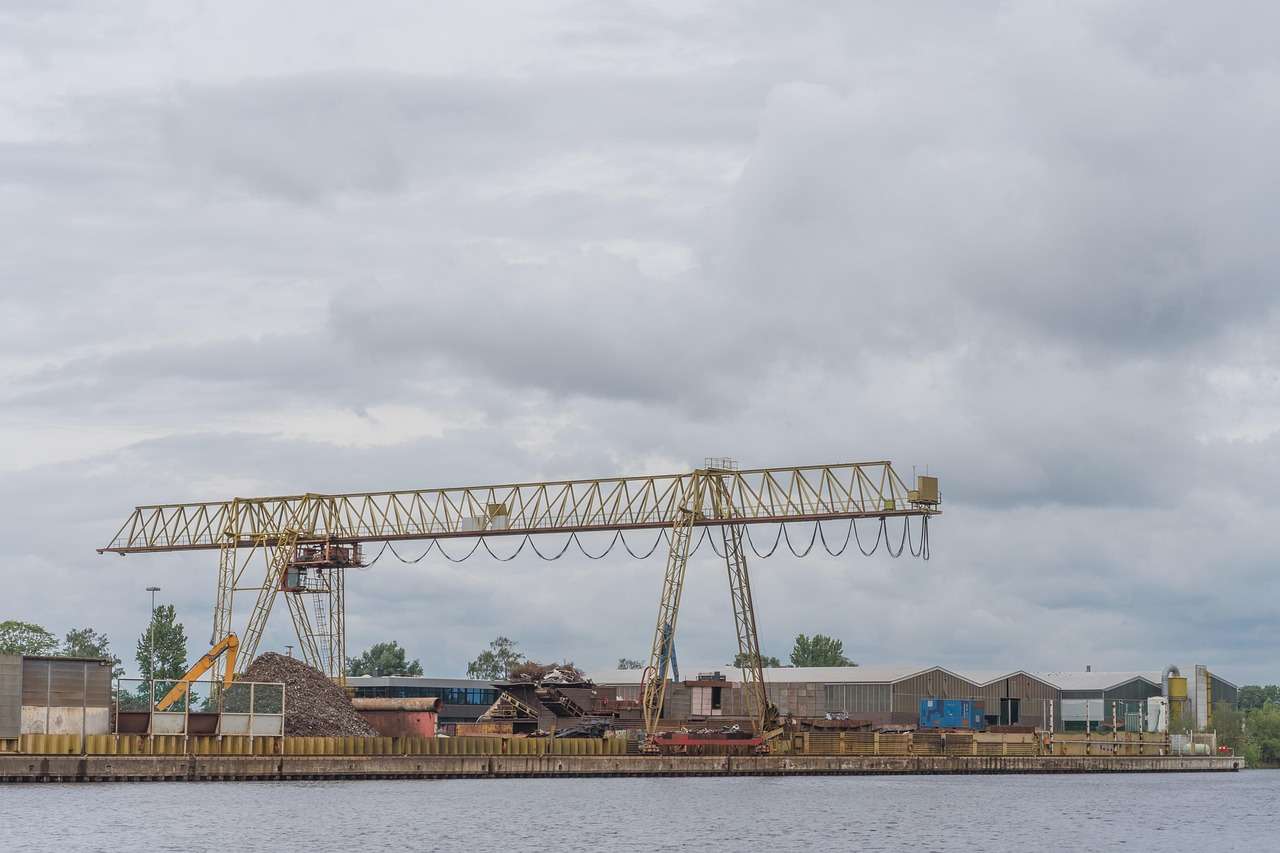 Material handler crane lifting scrap metal at a recycling yard