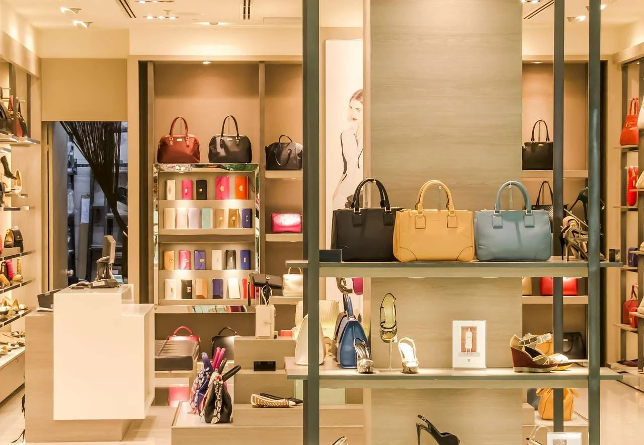 Boutique shopfit with lit display shelving for bags and shoes