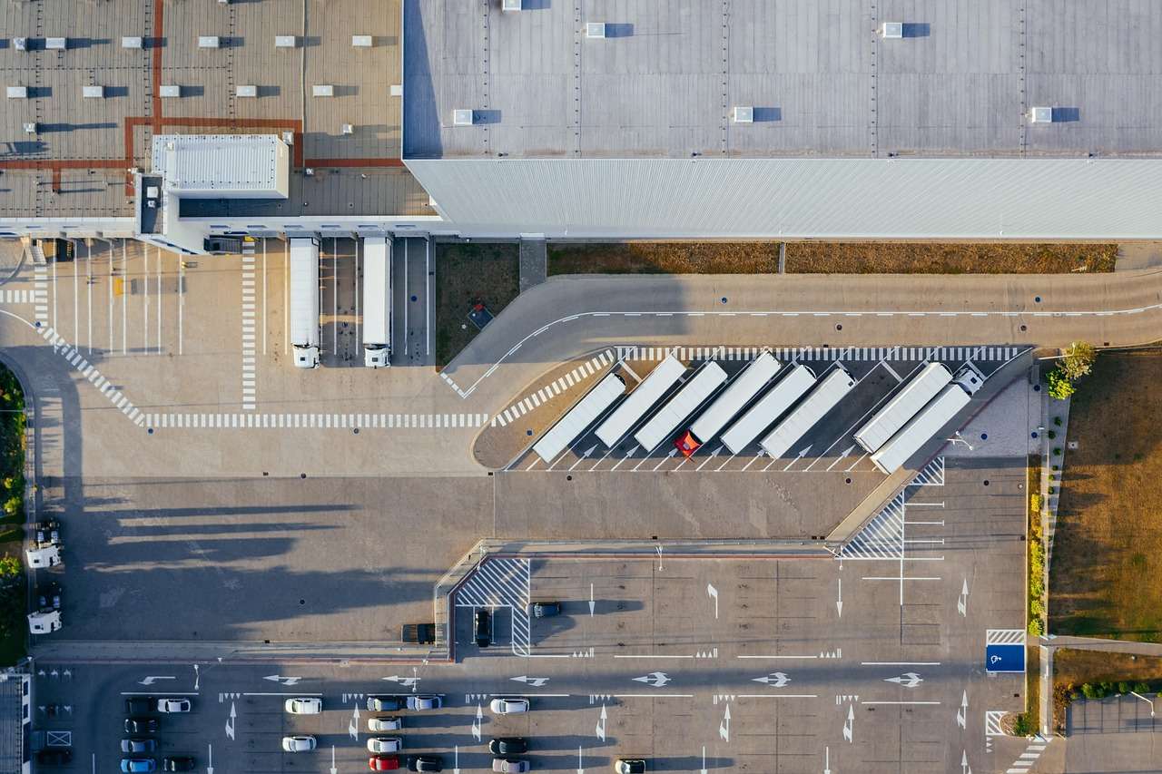 Aerial view of lorries and trailers at a UK distribution centre, the kind of business assets that asset finance pays for