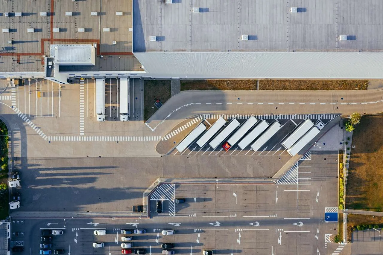 Aerial view of lorries and trailers at a UK distribution centre, the kind of business assets that asset finance pays for