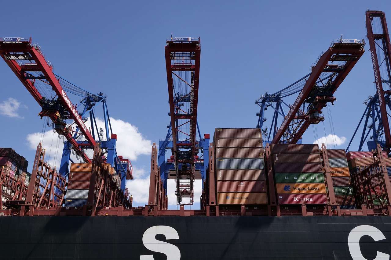 Container terminal with ship-to-shore cranes loading a container ship