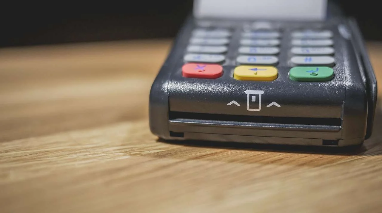 Self-service payment terminal with card slot and keypad