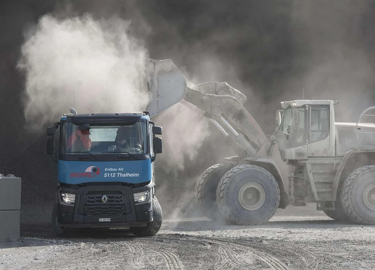 Loader filling a truck on a civil engineering site