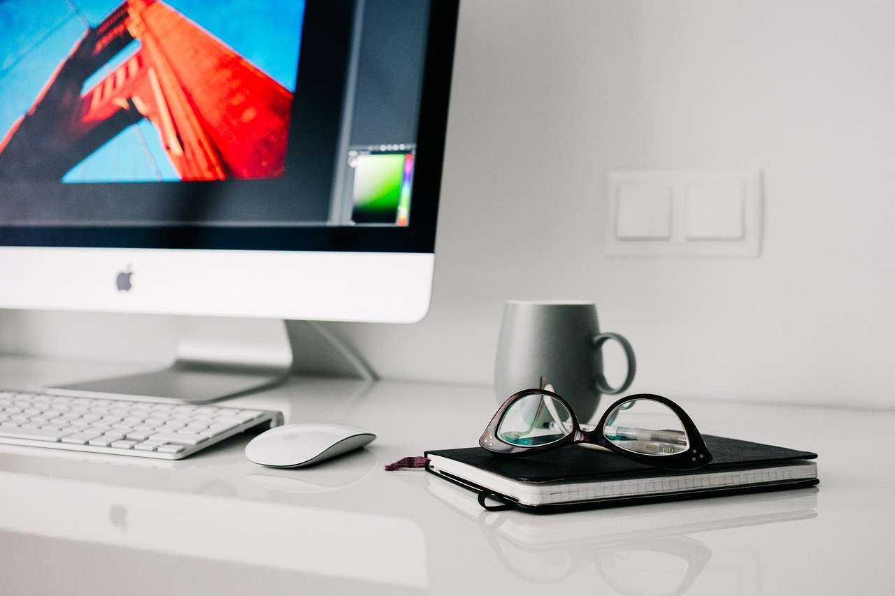 Desktop computer, laptop and office furniture in a modern workspace, business equipment funded through hire purchase and leasing
