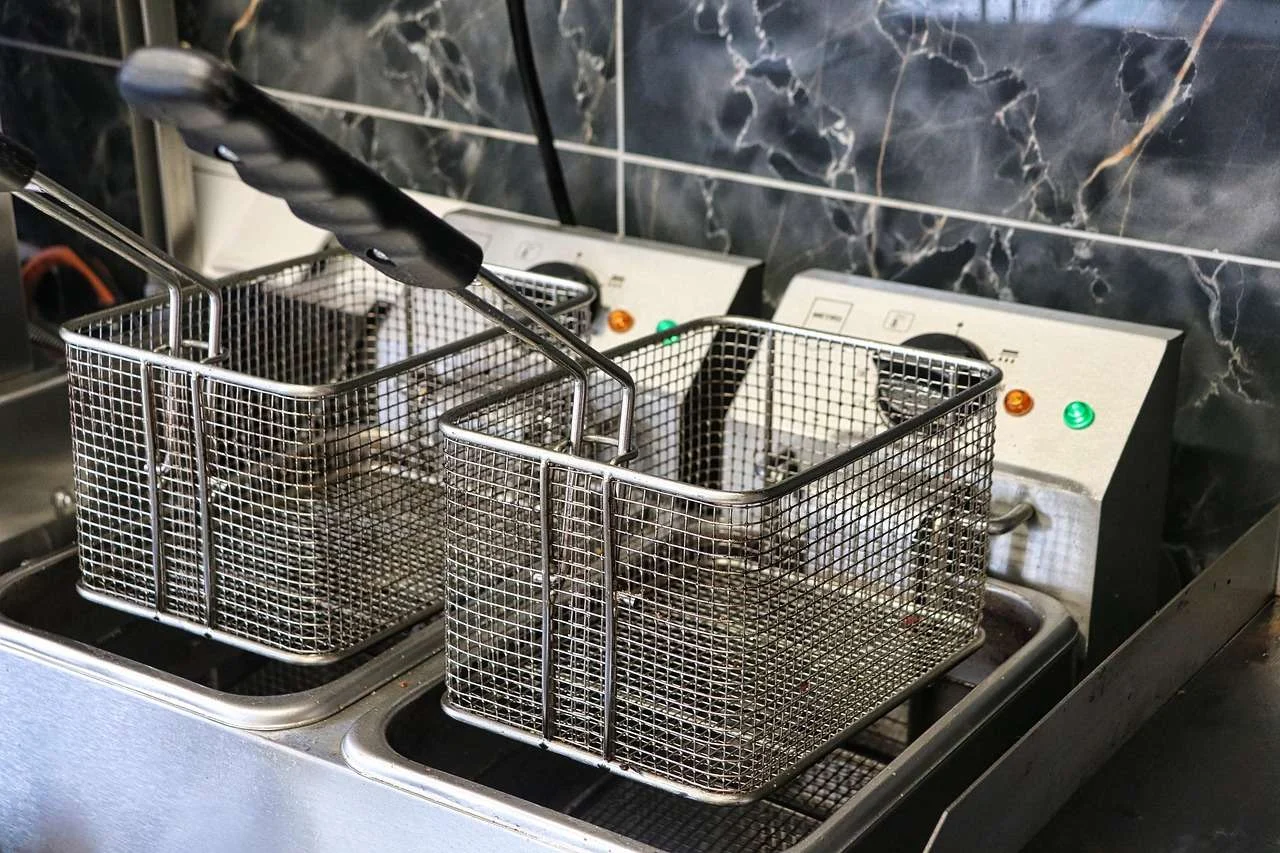 Commercial deep fryers on a fast food cooking line