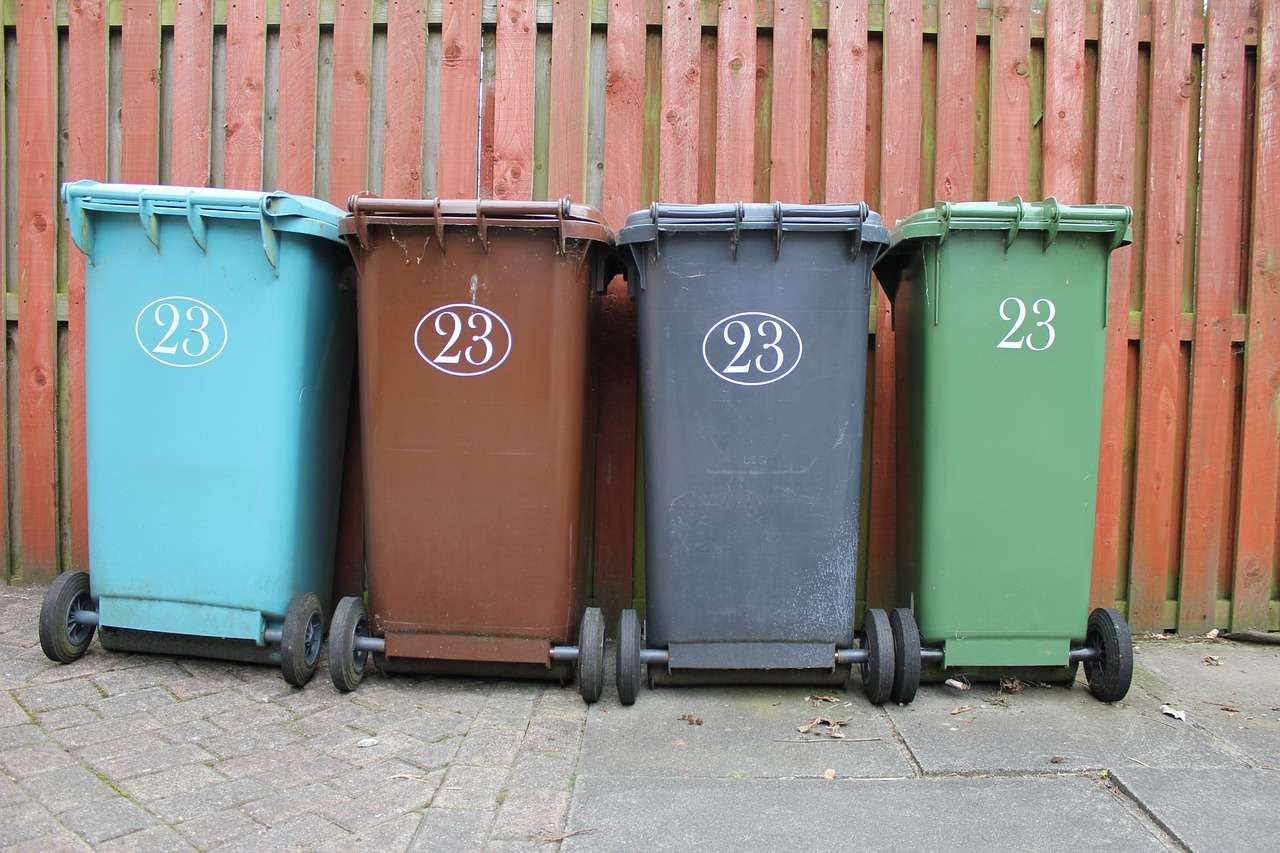 Row of coloured wheelie bins for waste and recycling collection