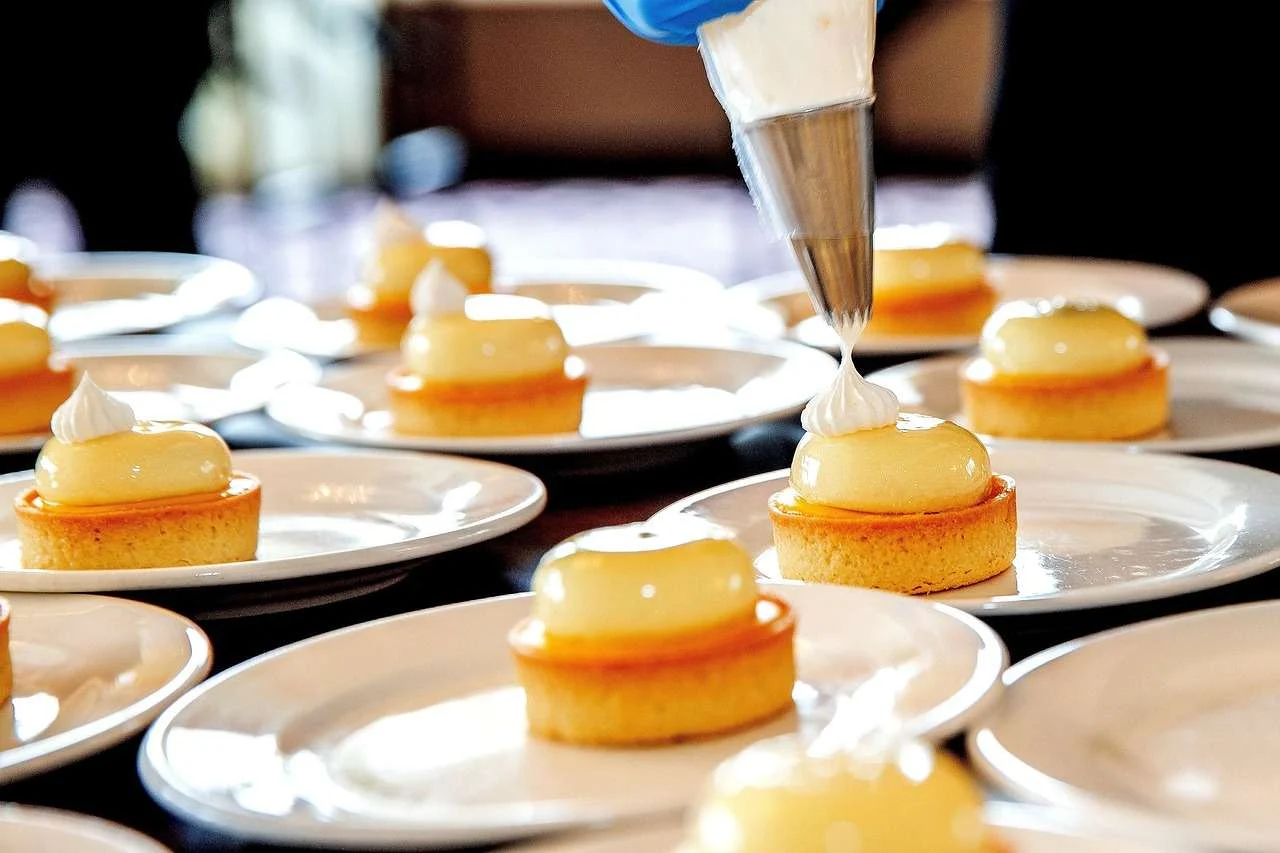 Chefs plating dishes in a professional restaurant kitchen