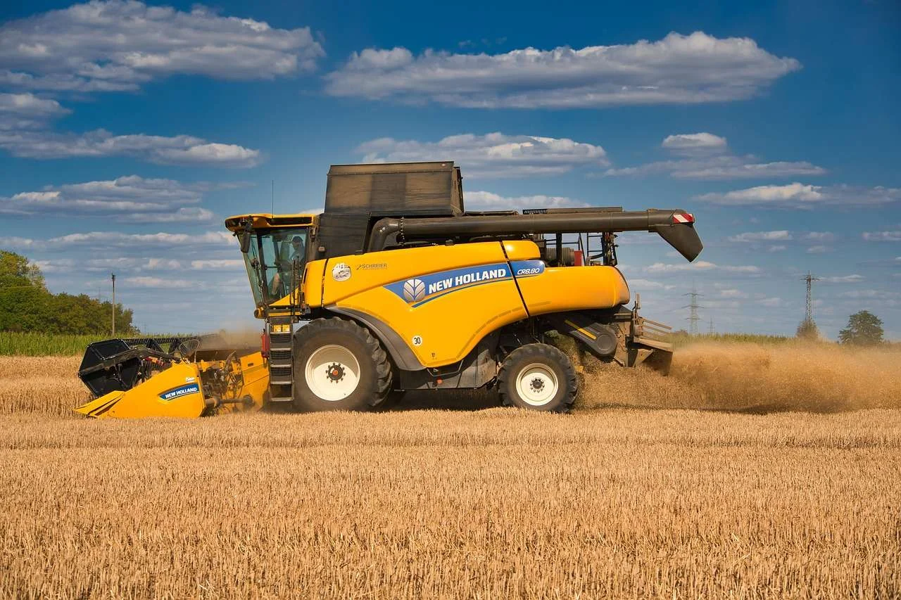 Combine harvester cutting wheat at harvest, a machine agricultural contractors fund on hire purchase