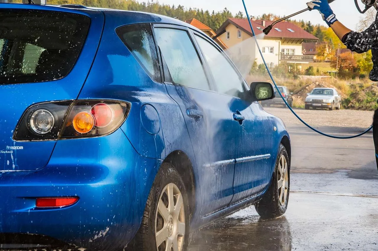 Snow foam being applied to a car wheel during a jet wash