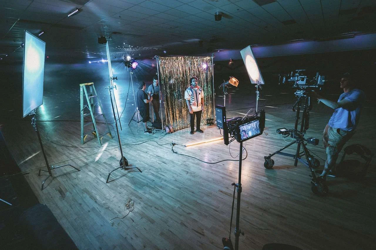 Video crew filming with professional cameras and studio lights