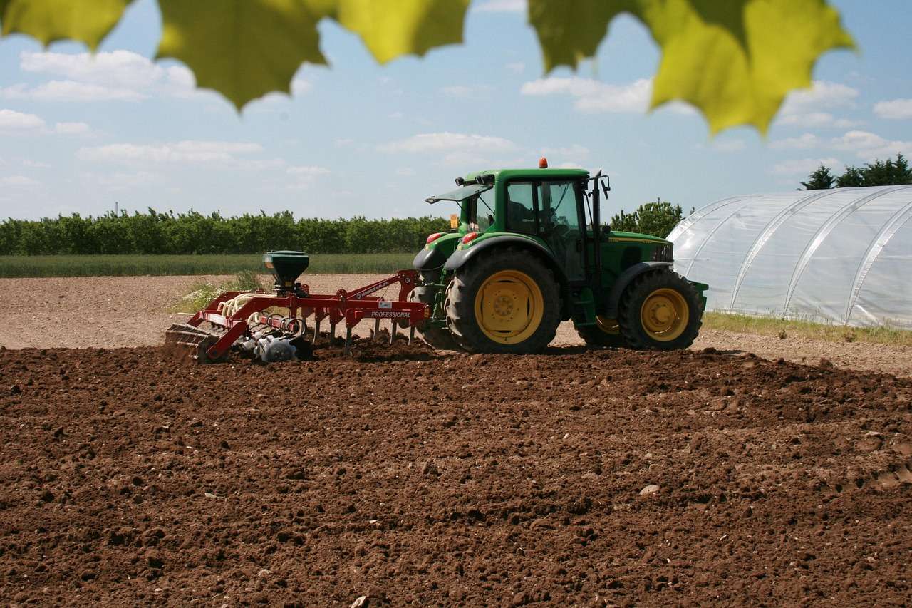 Tractor cultivating an arable field, the kind of machine funded through asset finance for agricultural contractors
