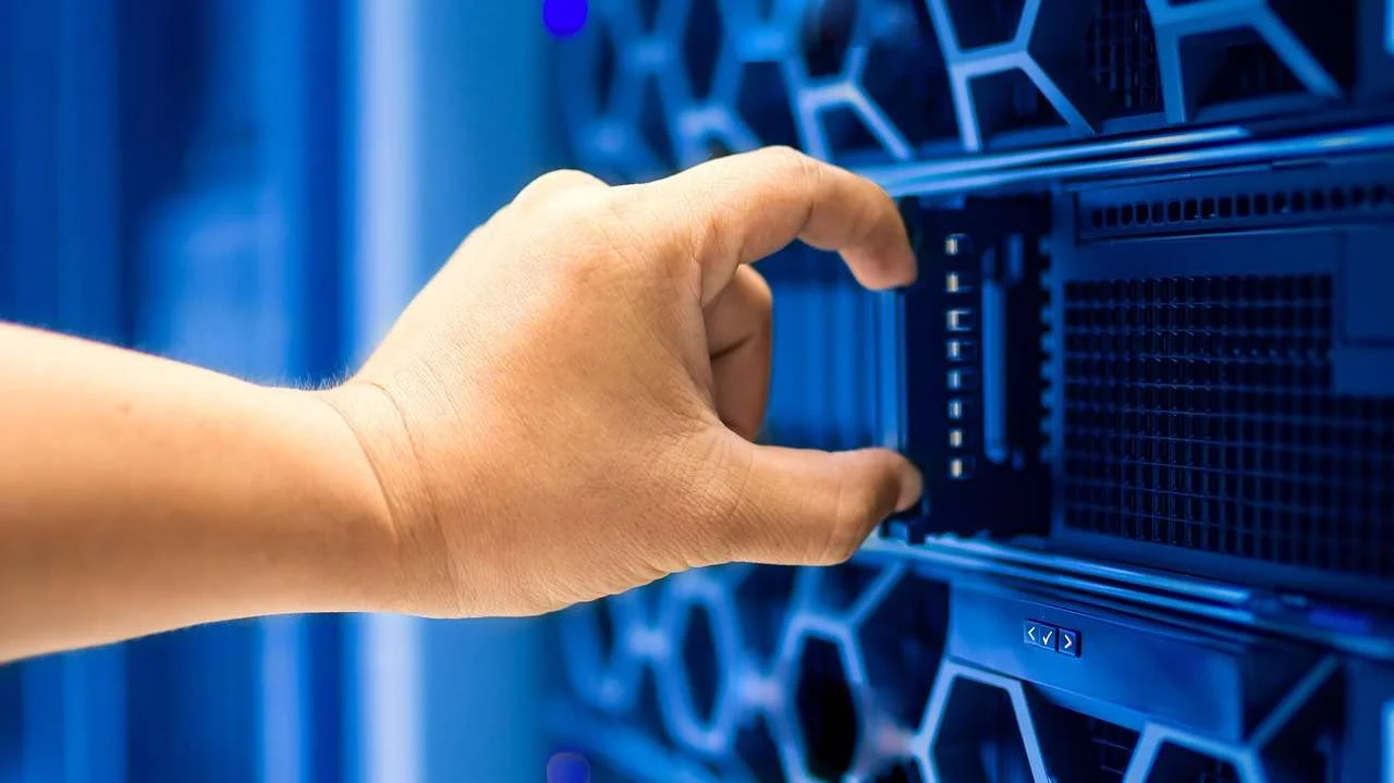 Engineer working on network cabling in a server room