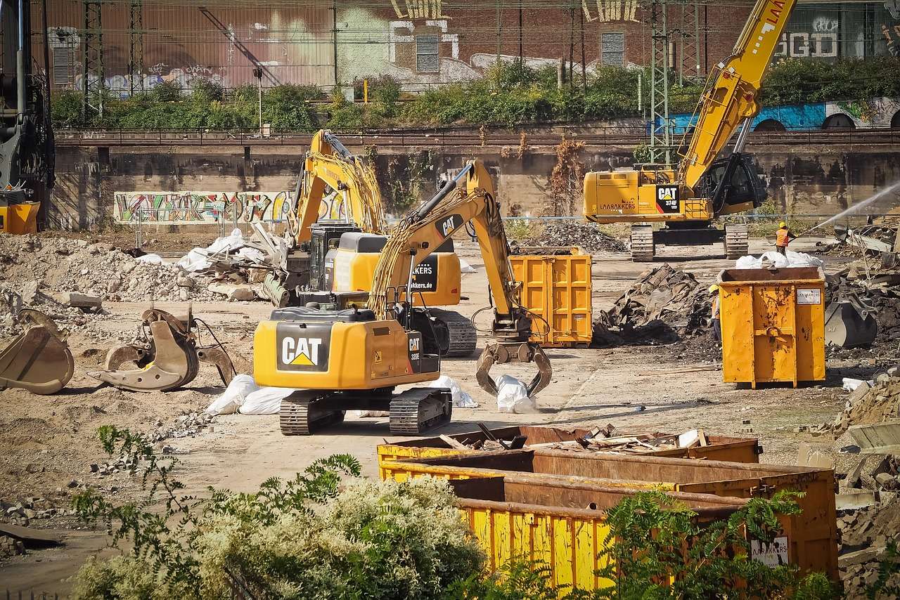 Waste skip finance for a demolition site with a skip container and excavator