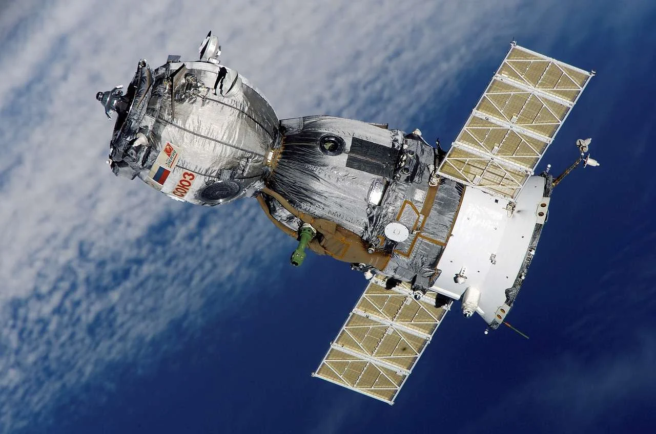 Satellite with solar panels in orbit above the Earth
