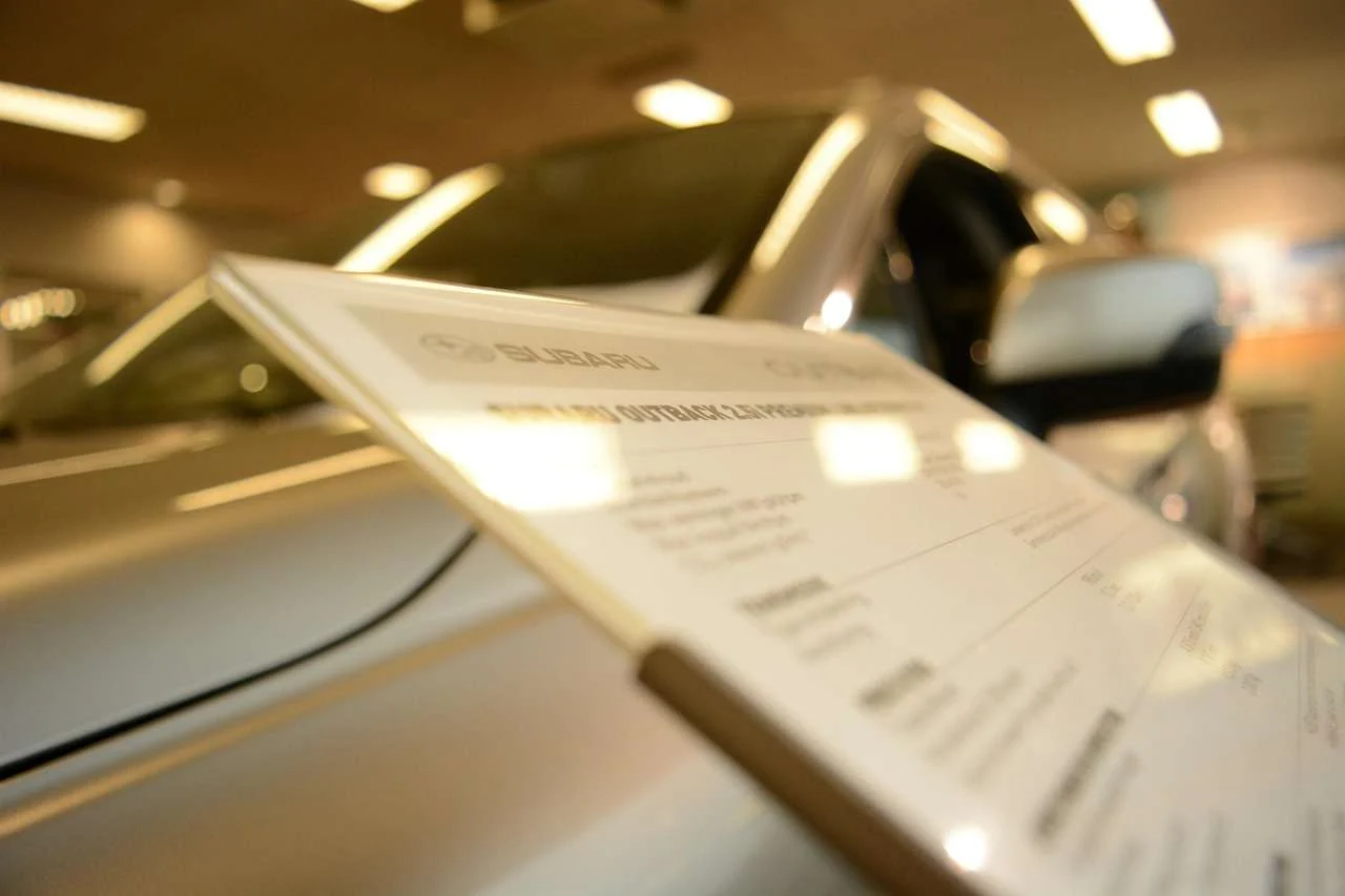 Used car dealer sign above cars for sale