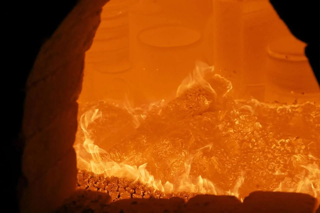 Flames inside a ceramic kiln during firing