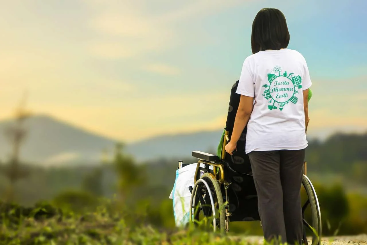 Carer pushing a resident in a wheelchair