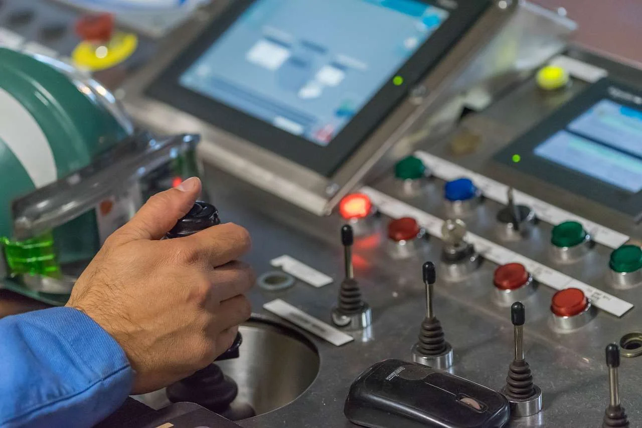 Operator using the control panel of an automated production line